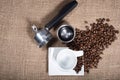 Espresso maker and coffee cup with beans on burlap sack Royalty Free Stock Photo