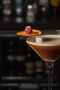 Espresso Martini Cocktail based on coffee, liqueur and vodka. Served with orange chips and raspberry. Space for text Royalty Free Stock Photo