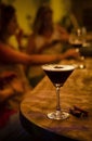 Espresso martini cocktail drink in cozy dark bar interior Royalty Free Stock Photo