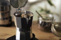 Espresso in Moka pot old coffee maker. Brewing black moka coffee using moka coffee maker Royalty Free Stock Photo
