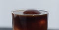 espresso over ice ball in tonic in tumbler glass on black wood table closeup Royalty Free Stock Photo