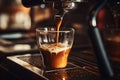 Espresso Pouring from Coffee Machine Flowing Into the Clear Small Glass in Cafe Royalty Free Stock Photo