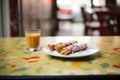 espresso shot beside cannoli on a caf table