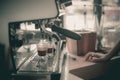 Espresso shot from coffee machine in coffee shop.