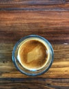 Espresso shot in glass on the vintage wooden table,