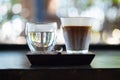 Espresso shot over cold fresh milk create gradient layer called Dirty coffee serve with warm water Royalty Free Stock Photo