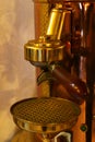 Espresso spout and brewing group on vintage steampunk looking coffee Espresso machine