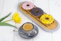 Espresso, sweet donuts with colorful icing.