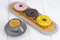 Espresso, sweet donuts with colorful icing.