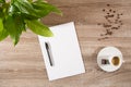 Espresso on table with green plant, coffee beans and white blank