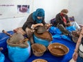 Two Moroccan homemade workers indoors