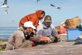 Local fishermen cleaning fresh fish in port. Essaouira, Morocco