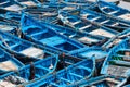 Essaouira, Morocco - March 16, 2018: A multitude of blue fishing boats typical of the city stuck together