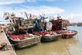 Essaouira, Morocco - March 16, 2018: Three fishing boats are moored in the port of Essaouira with the nets prepared on deck