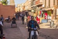 Essaouira, Morocco; 05, 14, 2016: Moroccan man rides an old motorbike down a crowded dirt road in Marrakesh, Morocco