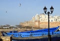 Essaouira Ramparts view with lantern and traditional blue ship in Essaouira, Morocco. Essaouira is a city in the western