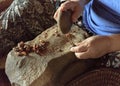 Making Argan Oil by Hand - smashing nuts open with a stone