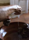 Making Argan Oil by Hand - squeezing pulp to release oil