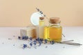 Essential or aromatic oil with jars of body and face cream. Dry lavender flowers, wood. Concept of natural natural cosmetics, spa Royalty Free Stock Photo