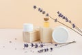 Essential or aromatic oil with jars of body and face cream. Dry lavender flowers, wood. Natural natural cosmetics concept Royalty Free Stock Photo