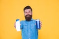 Essential for good hygiene. Hipster hold gel and shampoo bottles. Bearded man with hygiene products. Cosmetics and Royalty Free Stock Photo