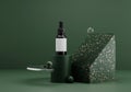 Essential oil bottle mockup. contemporary modern abstract composition in dark green tones with golden terrazzo and glass