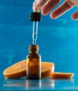 Essential oil bottle with orange slices and dropper Royalty Free Stock Photo