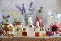 Essential oil bottles with frankincense resin, echinacea and lavender flowers