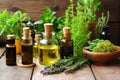 essential oil bottles with fresh herbs around