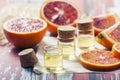 Essential oil citrus with orange slices, in glass bottle on ol Royalty Free Stock Photo