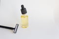 Essential oil dropper bottle and black disposable razor