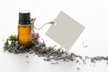 Essential oil, empty tags and lavender flowers