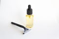 Disposable black razor and dropper glass bottle with essential oil