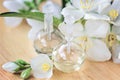 Essential oil in glass bottle with fresh jasmine flowers, beauty treatment. Spa concept Selective focus. Fragrant oil of jasmine f