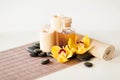 Essential oil, massage stones and orchid flower Royalty Free Stock Photo