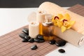 Essential oil, massage stones and orchid flower Royalty Free Stock Photo