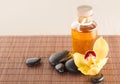 Essential oil, massage stones and orchid flower Royalty Free Stock Photo