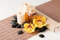 Essential oil, massage stones and orchid flower Royalty Free Stock Photo