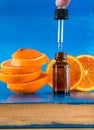 Essential oil with orange slices, bottle and dropper Royalty Free Stock Photo
