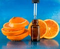 Essential oil with orange slices, bottle and dropper Royalty Free Stock Photo