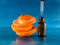 Essential oil with orange slices, bottle and dropper Royalty Free Stock Photo