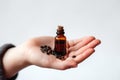 Essential Oil Of Palmarosa In Small Brown Bottle With Palmarosa In Womens Hands On White Background. Generative AI