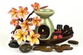 Essential oil, Plumeria flowers and the warped oil burner placed on a white background. Royalty Free Stock Photo