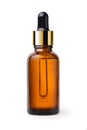 Essential serum oil in amber dropper bottle with gold cap