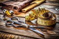 Essential Tailoring Tools Precision Scissors and Measuring Tape on a Rustic Wooden Surface Royalty Free Stock Photo