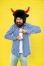 Essential vitamin you need. Bearded man open vitamin bottle. Hipster in hat with horns hold bottle of vitamin and