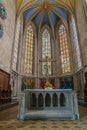 Alter and stained glass windows under high beautiful vaulted ceiling Royalty Free Stock Photo