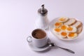 Esspresso coffee and soft boiled egg halves on the white plate and bread slices Royalty Free Stock Photo