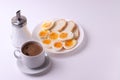 Esspresso coffee and soft boiled egg halves on the white plate and bread slices Royalty Free Stock Photo