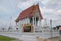 Sweeping tiered roof and ornate stucco artwork at Wat Kaen Lek, a Buddhist temple in Phetchaburi, Thailand